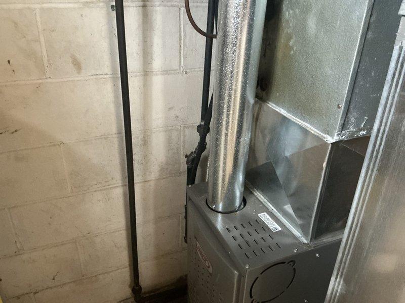 Responded to service call for water leaking from furnace/air handler unit in basement. Upon inspection, found condensate drainage issue where water was bypassing the drain pan and leaking from overflow port. Evaluated 34-year-old HVAC system and determined unit had reached end of serviceable life. Provided estimate for complete system replacement including new furnace and air conditioning equipment with proper condensate drainage configuration.