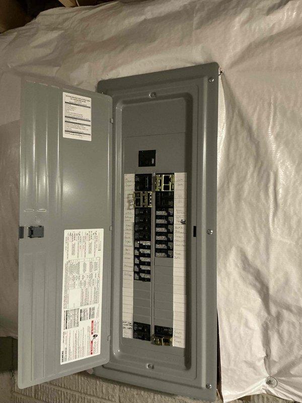 Conducted comprehensive electrical assessment for generator installation at residential property. Documented existing electrical panel configuration, including main service disconnect, circuit breaker arrangement, and load distribution across dual columns of breakers serving critical systems including water heater, HVAC units, and major appliances. Photographed panel interior specifications, circuit directory labels, and 20kA rated equipment to determine compatibility requirements and transfer switch integration points for proposed backup power system.