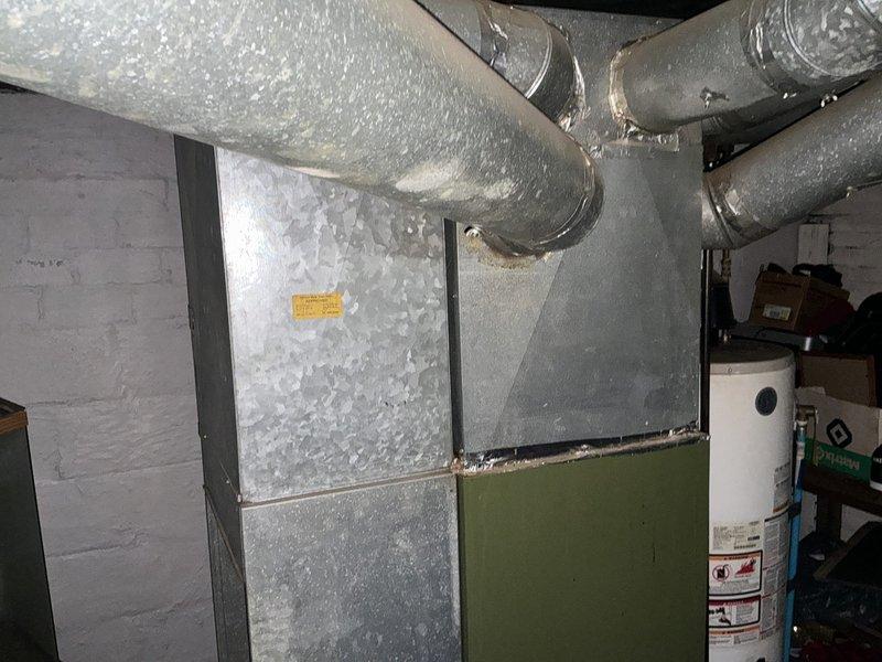 Conducted estimate for complete HVAC system replacement on 20-year-old equipment experiencing no cooling condition. Unit showing significant condensation accumulation on indoor air handler and ductwork indicating system failure, with outdoor condenser unit also requiring replacement due to age and performance issues.