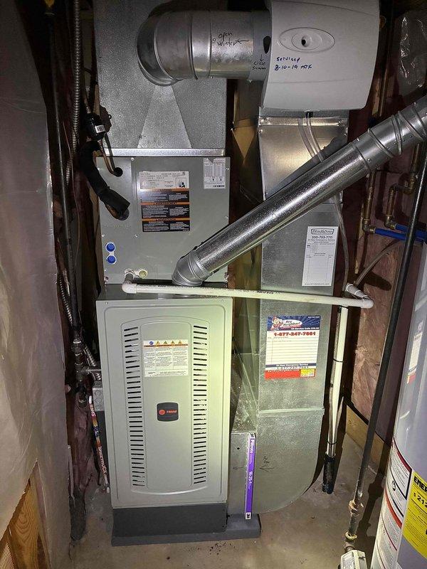 Completed MVP air conditioning maintenance on a 5-year-old Trane system. Performed comprehensive inspection of the air handler and furnace unit, verified all system components including blower motor, ductwork connections, and condensate drainage line were functioning properly. Temperature readings confirmed system operating within normal parameters at 115°F, indicating proper heat exchange and airflow through the equipment.