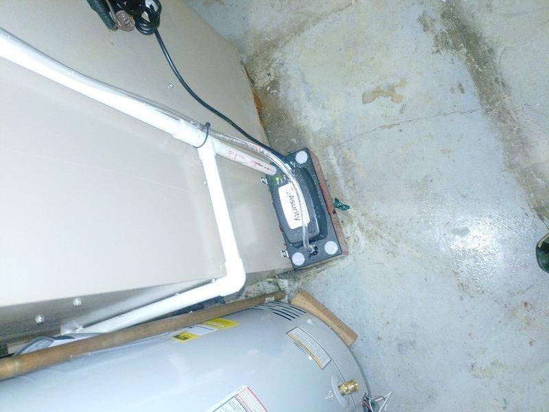 Responded to service call for water pooling in basement during air conditioner operation on a one-year-old Lennox system. Upon arrival, performed visual inspection of the indoor HVAC unit and surrounding area, documenting conditions with photographs. Identified water staining and moisture damage on basement concrete floor and walls near the equipment location. Inspected condensate drain line system, evaporator coil assembly, and drain pan for proper operation and potential blockages. Examined the insulated refrigerant lines, electrical components, and mounted contactors for any signs of condensation or refrigerant leaks that could contribute to water accumulation. Verified condensate pump operation if equipped, checked drain line routing and termination point, and ensured proper pitch for gravity drainage. Cleared any debris or biological growth from condensate system components and confirmed water flow through drain line during operation.