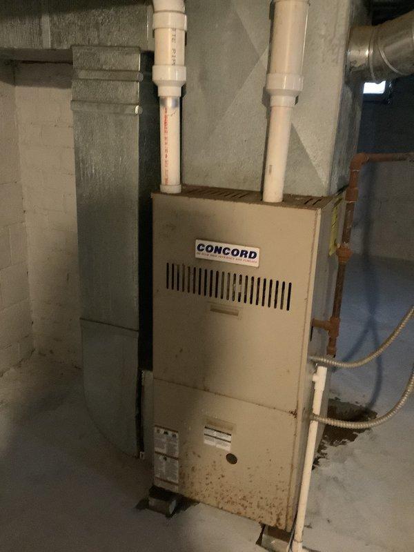Conducted on-site evaluation for complete central air conditioning system installation at owner-occupied residence. Assessed existing HVAC infrastructure including Concord brand furnace unit located in basement mechanical room, existing ductwork configuration with gray insulated supply ducts and metallic return air system, and residential electrical panel capacity for new AC condenser unit. Documented current system setup through photographic documentation of furnace installation, duct routing along concrete block walls, PVC drainage lines, and electrical service panel with circuit identification for load calculation purposes. Provided homeowner with comprehensive estimate for new central air system installation including equipment specifications, installation requirements, and available financing options through payment plan programs.