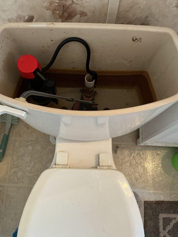 Responded to a toilet repair call at a mobile home. Upon inspection, found discolored water in the tank and outdated fill valve assembly with deteriorated components. Replaced the faulty fill valve with a new unit, including updated float mechanism and refill tube. Flushed system multiple times to clear sediment and verify proper tank filling and water shutoff. Adjusted water level to manufacturer specifications and confirmed no leaks at supply line connection. Tested flush mechanism for complete cycle operation and proper bowl refill.
