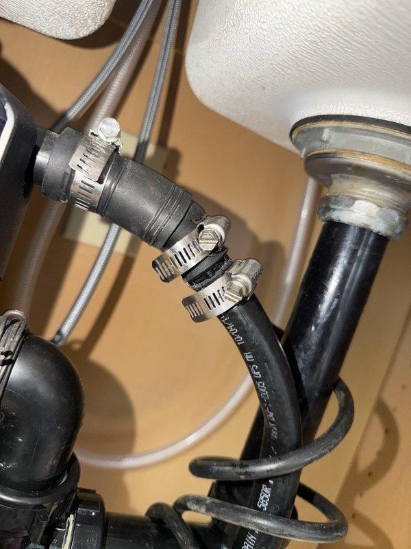Responded to service call for dishwasher drain hose leak at copper pipe coupling connection. Upon inspection, determined the dishwasher drain hose had separated from the existing copper pipe connection, which was independent of previous faucet and shut-off valve work performed at the property. Repaired the failed connection by coupling the dishwasher drain hose back to the copper pipe using a 3/4-inch coupling and securing with metal hose clamps. Performed operational test by running complete dishwasher fill and drain cycle to verify repair integrity with no leaks detected at the repaired connection point.