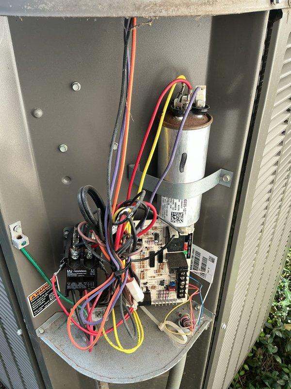 Responded to no cooling call on 6-year-old heat pump system with indoor temperature at 82 degrees. Upon inspection, found outdoor unit fan running but compressor not operating. Diagnosed failed dual run capacitor showing visible signs of corrosion and rust on terminal connections. Replaced defective capacitor with new unit, verified proper microfarad ratings, and tested system operation. Unit now cooling properly with compressor and condenser fan motor operating within normal parameters.