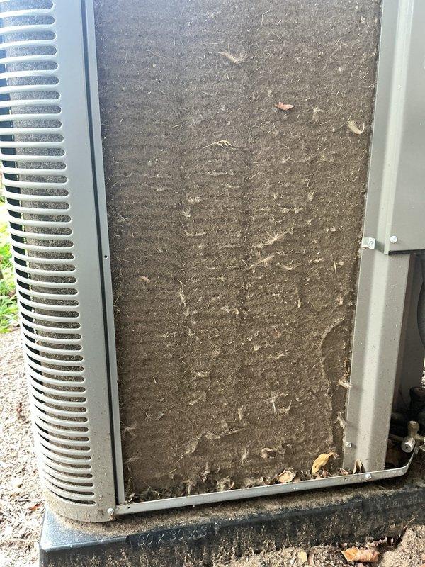 # HVAC Service Completed

Responded to no cooling complaint on 2-year-old residential air conditioning system. Upon arrival, performed visual inspection of outdoor condensing unit. Found condenser coil heavily restricted with dirt, dust, and debris accumulation, significantly impeding airflow through the unit. Organic material including leaves and twigs were embedded in the coil fins and surrounding areas.

Cleaned condenser coil thoroughly to restore proper airflow and heat transfer capability. Removed all debris from unit exterior and surrounding pad area. System airflow restored to manufacturer specifications. Unit tested and confirmed returning to normal cooling operation following cleaning service.