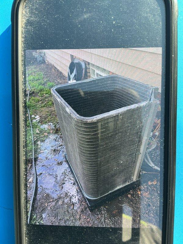 # HVAC Service Completed

Responded to no cooling complaint on 2-year-old residential air conditioning system. Upon arrival, performed visual inspection of outdoor condensing unit. Found condenser coil heavily restricted with dirt, dust, and debris accumulation, significantly impeding airflow through the unit. Organic material including leaves and twigs were embedded in the coil fins and surrounding areas.

Cleaned condenser coil thoroughly to restore proper airflow and heat transfer capability. Removed all debris from unit exterior and surrounding pad area. System airflow restored to manufacturer specifications. Unit tested and confirmed returning to normal cooling operation following cleaning service.
