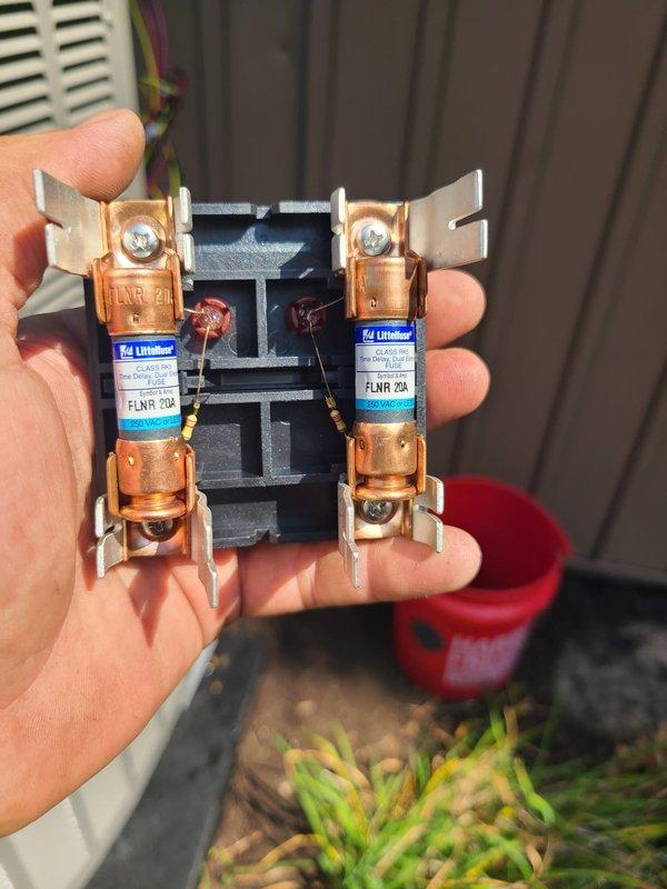 Completed installation of smaller dual-zone heat pump system including outdoor condenser unit and indoor air handler. Installed 20-amp FLNR fuses in disconnect box, positioned outdoor unit on concrete pad with proper refrigerant line connections and service valves, and verified all electrical connections meet code requirements.