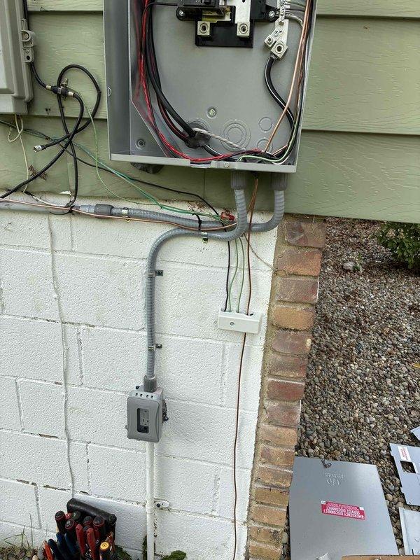 Completed 100-amp electrical service upgrade with installation of exterior disconnect panel in compliance with 2023 National Electrical Code requirements. Updated grounding system to current code standards and installed whole home surge protection device (HEPD80). Installed new panel kit with proper conduit routing along exterior wall, securing all conduits with appropriate mounting hardware to foundation and siding. Terminated all service conductors to code specifications with proper color-coded wiring connections at main panel and disconnect. All work tested and verified operational upon completion.