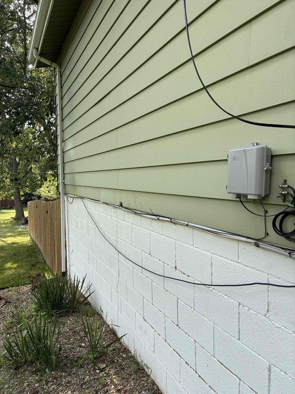 Completed 100-amp electrical service upgrade with installation of exterior disconnect panel in compliance with 2023 National Electrical Code requirements. Updated grounding system to current code standards and installed whole home surge protection device (HEPD80). Installed new panel kit with proper conduit routing along exterior wall, securing all conduits with appropriate mounting hardware to foundation and siding. Terminated all service conductors to code specifications with proper color-coded wiring connections at main panel and disconnect. All work tested and verified operational upon completion.