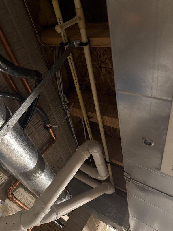 Installed dedicated electrical outlet for tankless water heater in utility area. Ran new circuit wiring through basement space to power unit, ensuring proper amperage and code compliance for the tankless water heating system.