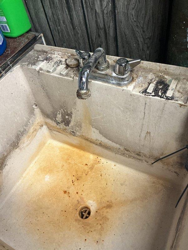 Responded to service call for leaky laundry tub faucet and exterior hose spigot replacement. Accessed crawl space to inspect water supply lines and replaced deteriorated outdoor hose bibs. Repaired dripping faucet assembly on utility sink, addressing corrosion and mineral buildup that had compromised seal integrity. All fixtures tested and verified leak-free upon completion.