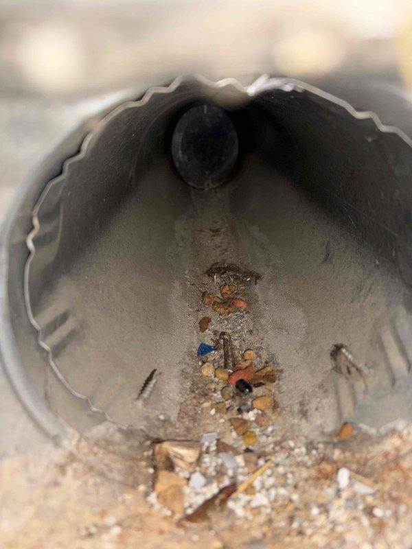 Completed indoor air quality assessment and ductwork inspection in residential crawl space. Documented significant debris accumulation within metallic flex duct system, including construction materials and particulate matter along interior surfaces. Evaluated crawl space conditions with vapor barrier in place and assessed overall HVAC system accessibility for potential air quality improvements.