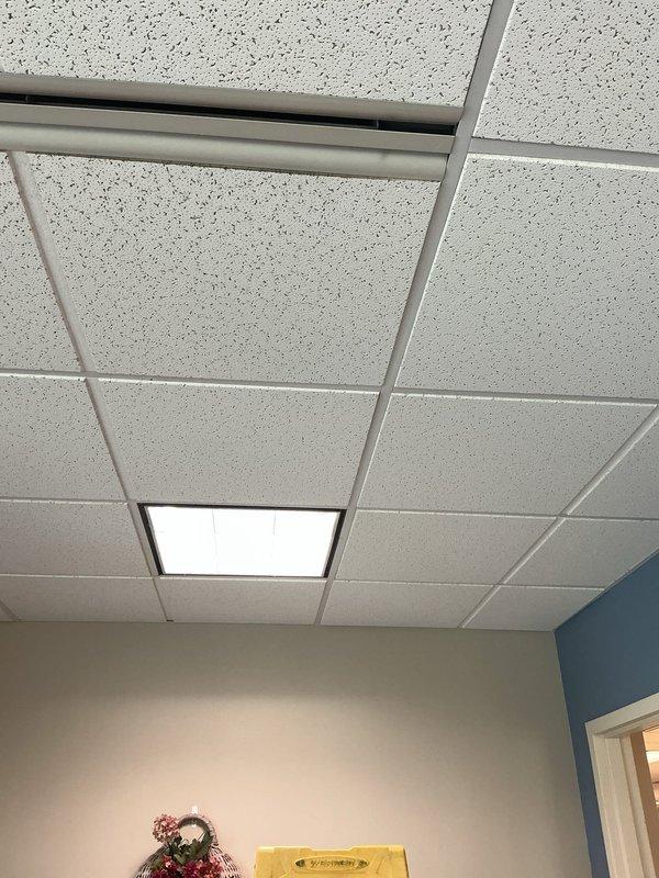 Responded to service call for ceiling light replacement in office space. Removed existing fluorescent light fixtures from suspended acoustic tile ceiling system and installed new LED recessed light fixtures with white trim. Verified proper electrical connections, tested illumination levels, and ensured all ceiling tiles were properly reinstalled in grid system. All lighting fixtures now operational and functioning correctly.