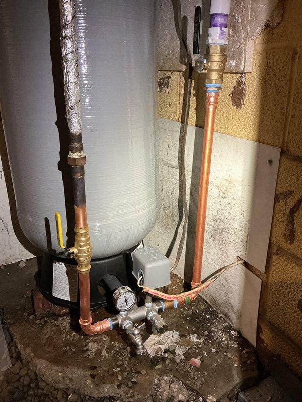 Replaced existing pressure tank with new 30-gallon FLEX-LITE pressure tank. Installation included new pressure switch, tee fitting, pressure gauge, drain valve, and relief valve. Installed new shut-off valve on threaded PVC supply line upstream of tank. All copper pipe connections completed with brass fittings and properly secured. System tested and verified operational upon completion.