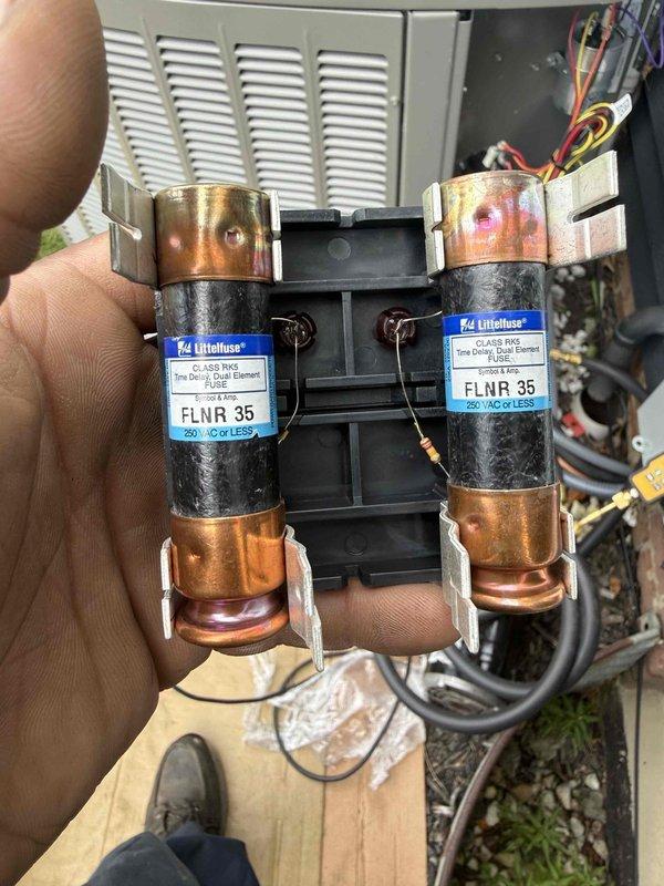 Completed installation of a 90% efficiency furnace and air conditioning system. Installed new electrical disconnect with FLNR 35 amp fuses rated at 250 volts, established proper electrical connections with color-coded wiring, and mounted outdoor condensing unit. Inside mechanical room, installed furnace unit with associated PVC condensate drainage system featuring multiple drain lines and proper pitch for water removal. Routed black flexible electrical conduit for system controls and power supply, installed safety float switch on drainage system, and established all necessary connections to existing ductwork. System tested and verified operational with all safety devices functioning properly.