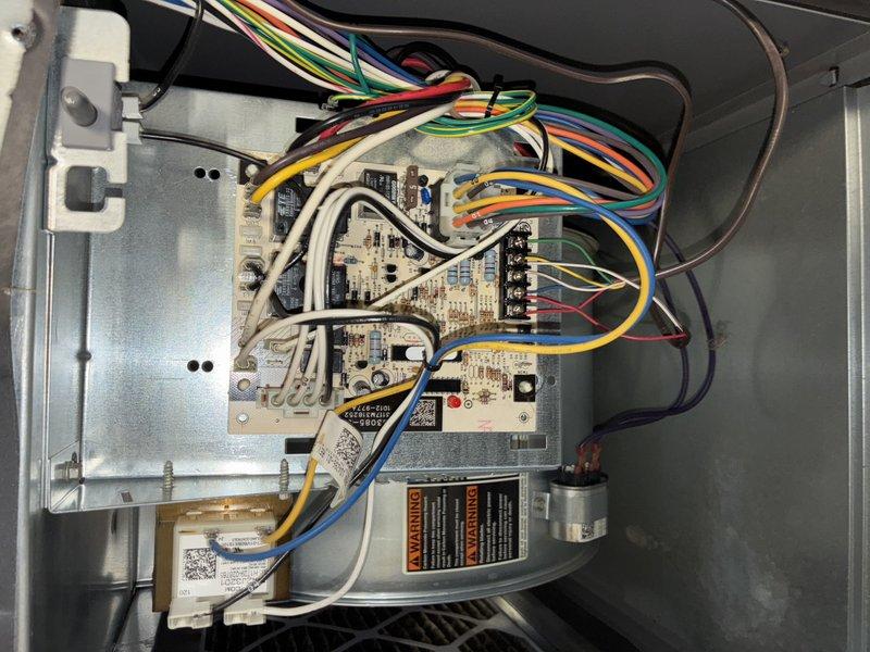 Completed MVP recurring cooling maintenance visit on HVAC system of unknown age. Performed comprehensive system inspection including examination of control board, electrical connections, and evaporator coil assembly. Control panel revealed properly functioning circuit board with all relays, capacitors, and terminal blocks operating within normal parameters. All multicolored control wiring connections were verified secure with no signs of overheating or deterioration. Capacitor and motor starter components inspected and found in good working condition.

Evaporator coil inspection revealed moderate dirt and debris accumulation between aluminum fins, which is typical for normal system operation. Coil fins showed varying degrees of cleanliness with particulate matter lodged in narrow gaps that could restrict airflow if left unaddressed. All mounting brackets and housing components were secure and properly installed. System electrical components and wiring organization confirmed to meet pro