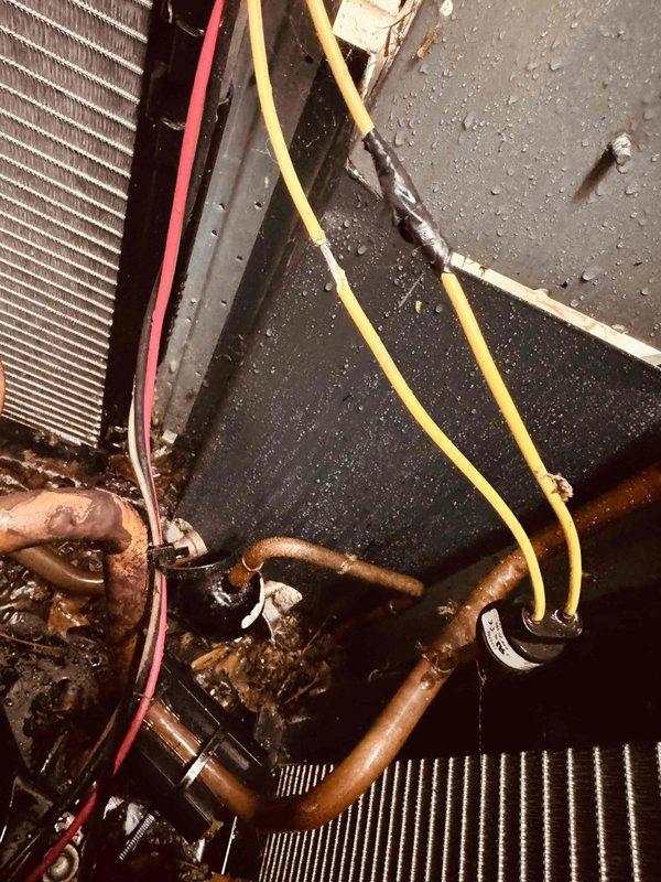 Responded to service call for AC unit short cycling and shutting off every few seconds. Upon inspection, discovered severely corroded copper refrigerant lines and deteriorated electrical connections contributing to system failure. Documented extensive rust and oxidation on refrigerant piping, moisture accumulation on interior panels, and compromised wire connections requiring repair. System required immediate attention due to degraded components affecting proper operation and causing the reported short cycling condition.