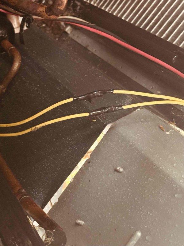 Responded to service call for AC unit short cycling and shutting off every few seconds. Upon inspection, discovered severely corroded copper refrigerant lines and deteriorated electrical connections contributing to system failure. Documented extensive rust and oxidation on refrigerant piping, moisture accumulation on interior panels, and compromised wire connections requiring repair. System required immediate attention due to degraded components affecting proper operation and causing the reported short cycling condition.