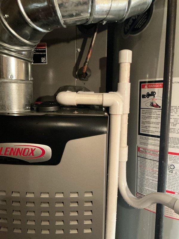 Responded to service call for excessive basement moisture following recent AC installation. Inspected Lennox air conditioning system and indoor furnace unit for potential water leaks or condensate drainage issues. Examined condensate drain lines, PVC piping connections, and drainage system routing to identify source of moisture accumulation. Verified proper condensate pump operation and checked for any blockages in drain lines. Inspected evaporator coil drain pan for cracks or overflow conditions. Assessed outdoor condenser unit placement and surrounding area for proper drainage away from foundation. No active water leaks observed on floor during inspection, but confirmed significant dehumidifier usage indicating elevated humidity levels. Evaluated condensate management system integrity and provided recommendations to address moisture concerns related to HVAC operation.