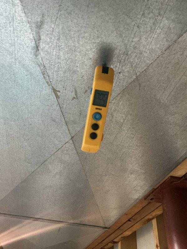 Responded to complaint of loud noise from AC unit. Performed diagnostic assessment and took temperature measurements at ceiling level registering 50.9°F, indicating proper cooling function. Inspected accessible components and documented conditions for service records.