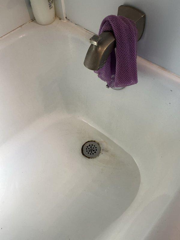 Responded to service call for clogged bathtub drain. Upon arrival, found drain obstructed with visible signs of buildup and reduced water flow. Removed drain cover and cleared blockage using appropriate drain cleaning tools. Inspected faucet assembly and noted significant mineral deposits on chrome fixtures. Tested drain flow after clearing obstruction to ensure proper drainage was restored. Completed work and verified bathtub draining properly.