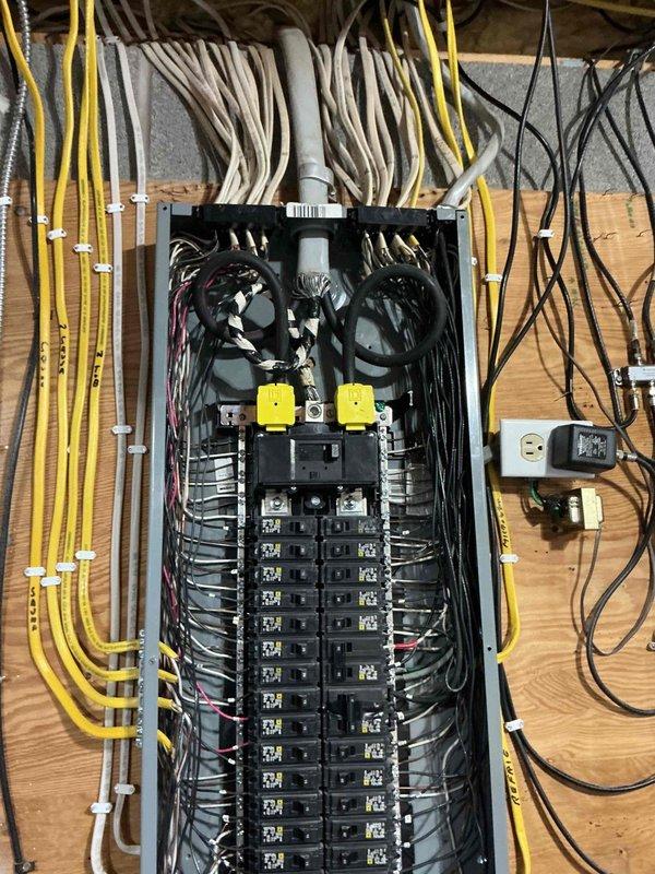Conducted on-site evaluation for backup generator installation at residential property. Assessed existing electrical infrastructure including main service panel and exterior utility connections. Documented current electrical panel configuration with dual main disconnects and circuit breaker arrangement to determine integration requirements for automatic transfer switch. Evaluated exterior mounting location near existing gas meter assembly and assessed adequate clearance for generator placement on gravel pad area. Photographed electrical panel wiring configuration and exterior utility area to prepare comprehensive installation estimate including necessary electrical modifications, transfer switch installation, and generator pad preparation requirements.