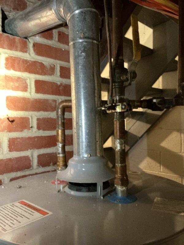 Responded to service call for multiple plumbing issues including leaking PVC drain line in basement and shower head replacement. Inspected under-sink plumbing configuration with white PVC P-trap assembly and garbage disposal connections, checking for proper drainage and seal integrity. Addressed basement plumbing concerns involving water heater or mechanical system connections with galvanized and copper piping. Completed repairs from customer's maintenance list, ensuring all connections were secure and leak-free.
