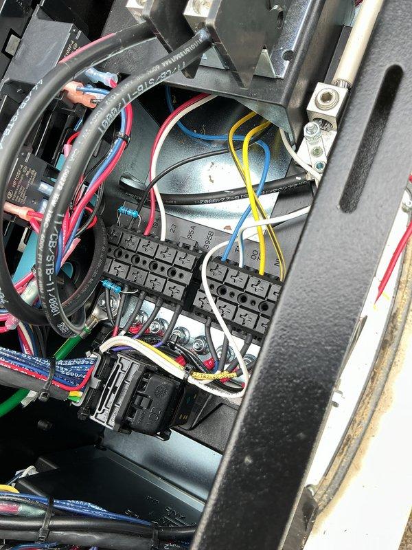Responded to service call for 2-month-old generator displaying miswire alarm and failure to exercise. Diagnosed E-CODE-2009 wiring error through control panel diagnostics, inspected terminal block connections and phase wiring configuration within the transfer switch assembly. Corrected miswired connections, verified proper phasing on all three legs, and cleared error codes from system log. Unit successfully tested and returned to automatic operation with proper exercise scheduling restored.