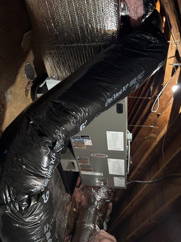 # HVAC System Replacement and Ductwork Installation

## Work Performed

Completed full HVAC system replacement in attic space, removing existing equipment and installing new air handler unit with proper configuration. Replaced all attic ductwork to establish correct airflow distribution throughout the system. 

The existing air handler was disconnected and removed from service. A new Sonnet brand air handler unit was positioned and secured vertically in the attic space between structural joists. The unit was installed with proper clearances for serviceability and airflow requirements.

All old ductwork was removed from the attic. New flexible ductwork was installed and connected to the air handler, routed through the attic framing with appropriate support and secured with metal clamps and mounting brackets. Metallic flexible conduit was installed for electrical connections, attached to white metal panels using proper mounting hardware.

Reflective insulated ductwork was installed throu