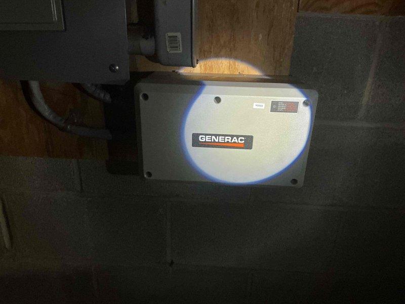 Responded to no-power condition affecting HVAC system following recent power outage. Upon arrival, confirmed thermostat and AC unit were completely non-operational. Investigated electrical supply chain and located Generac transfer switch control unit in basement utility area with no indicator lights present, confirming loss of power to HVAC equipment. Documented existing conditions with photos showing transfer switch and associated electrical panels in non-powered state. Verified power outage had affected transfer switch operation, resulting in downstream loss of power to climate control system. Advised that replacement of control unit may be necessary and scheduled follow-up service visit to install new equipment and restore full system functionality.