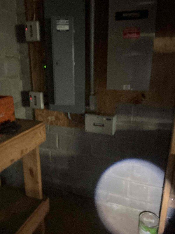 Responded to no-power condition affecting HVAC system following recent power outage. Upon arrival, confirmed thermostat and AC unit were completely non-operational. Investigated electrical supply chain and located Generac transfer switch control unit in basement utility area with no indicator lights present, confirming loss of power to HVAC equipment. Documented existing conditions with photos showing transfer switch and associated electrical panels in non-powered state. Verified power outage had affected transfer switch operation, resulting in downstream loss of power to climate control system. Advised that replacement of control unit may be necessary and scheduled follow-up service visit to install new equipment and restore full system functionality.