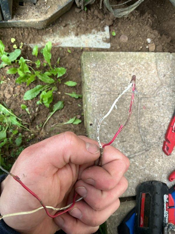Responded to no cooling call on residential air conditioning system connected to five-year-old gas furnace. Customer reported 3-amp fuse in furnace blew twice - once replaced by customer with system operating 24 hours before second failure. Upon arrival, performed system diagnostics and traced repeated fuse failure to damaged low-voltage wiring between outdoor condensing unit and indoor air handler. Located compromised wire section buried in soil near outdoor unit with exposed copper conductors and deteriorated insulation. Tested voltage and continuity on affected circuits to confirm wiring fault as root cause of overcurrent condition. Replaced damaged wire section with new low-voltage control wiring, ensuring proper burial depth and protection. Installed new 3-amp fuse, verified all electrical connections, and tested system operation through complete cooling cycle. System restored to normal operation with no further fuse failures.