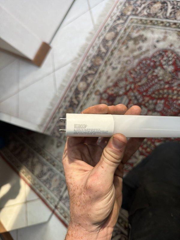 Converted 3-foot fluorescent light fixture to LED bypass bulbs. Verified existing wiring compatibility and confirmed 120V power supply at fixture location. Removed original fluorescent tubes and completed LED retrofit installation.