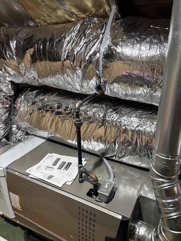 Returned to site to address furnace door installation issue and complete return air ductwork installation. Successfully secured furnace access door to ensure proper seal and safe operation of the air handler unit. Installed additional flexible return air ducts to optimize airflow distribution throughout the attic-mounted HVAC system, connecting to the beige air handler unit mounted on platform. All ductwork properly wrapped in reflective insulation and secured according to manufacturer specifications and code requirements.