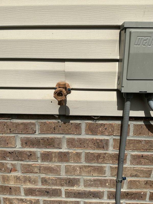 Installed new shutoff valve for ice maker line using compression-by-compression connection, requiring ceiling access in basement for proper installation. Removed existing outdoor sillcock and replaced with frost-free sillcock equipped with shutoff valve to prevent freeze damage. Installed access panel at spigot location for future maintenance accessibility.