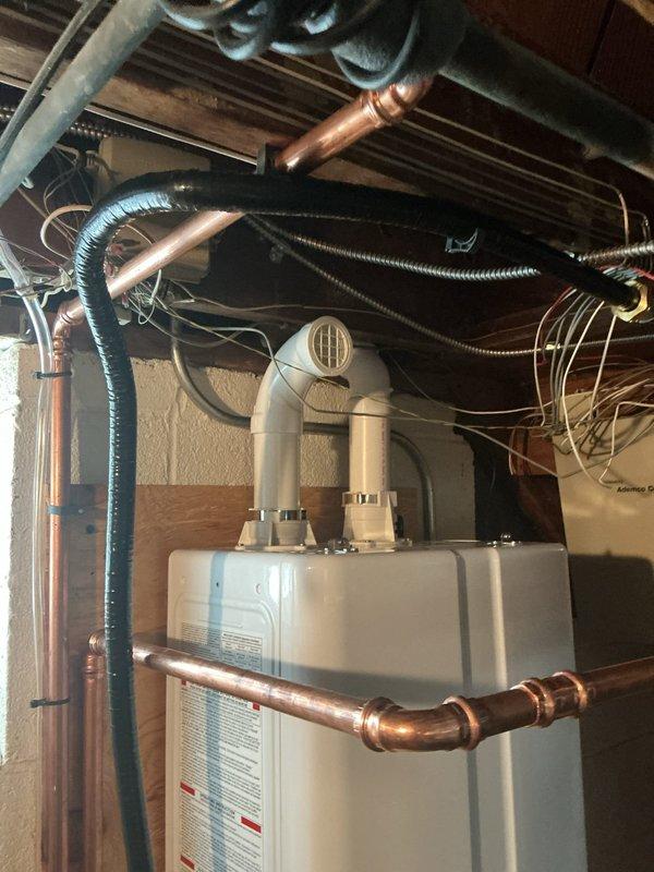Installed dedicated 240V electrical outlet in basement utility area to support new tankless water heater installation. Ran appropriate gauge wiring from existing electrical panel through exposed joist space, secured all conduit and cabling per code requirements, and mounted weatherproof outlet box on wooden framing adjacent to water heater location. Verified proper grounding and circuit protection to ensure safe operation of tankless unit.