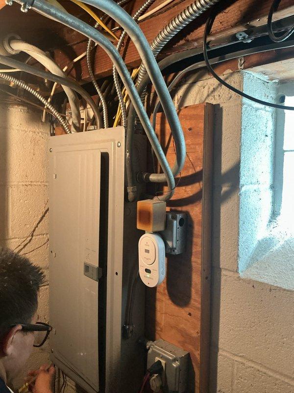 Installed dedicated 240V electrical outlet in basement utility area to support new tankless water heater installation. Ran appropriate gauge wiring from existing electrical panel through exposed joist space, secured all conduit and cabling per code requirements, and mounted weatherproof outlet box on wooden framing adjacent to water heater location. Verified proper grounding and circuit protection to ensure safe operation of tankless unit.