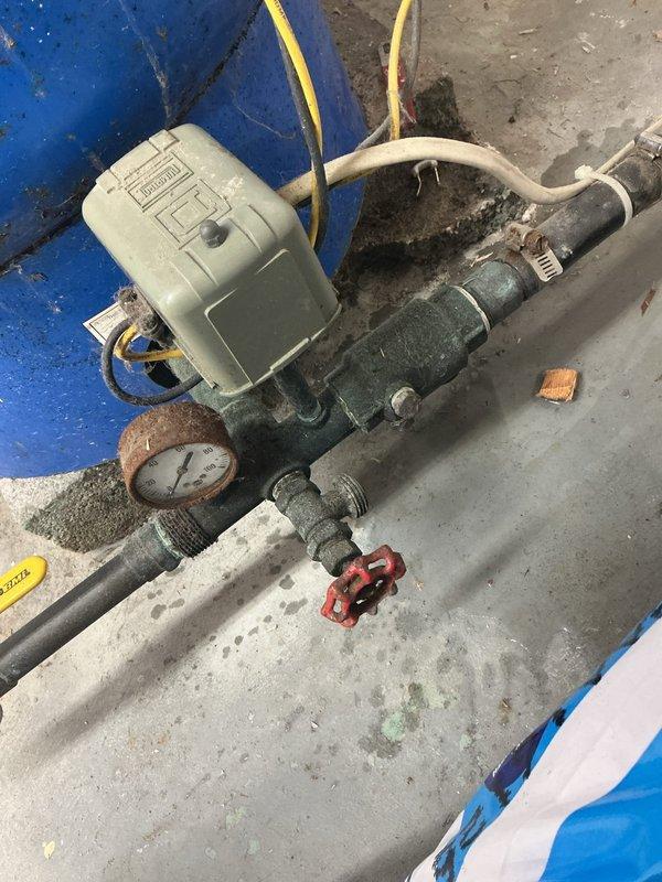 Responded to no water/zero pressure complaint at residential property on well system. Upon arrival, inspected well pump system and electrical components in mechanical room. Found faulty pressure switch and relay assembly preventing pump operation. Tested electrical connections at junction box and verified power supply to pump motor. Replaced defective pressure switch and cleaned corroded terminals on relay contactor. Inspected green circulation pump for proper operation and verified all gate valves were in open position. Checked pressure gauge readings and confirmed system was building adequate pressure. Cycled pump multiple times to ensure proper cut-in/cut-out function of new pressure switch. Restored full water pressure throughout residence and verified flow at multiple fixtures. System operating normally at time of departure.