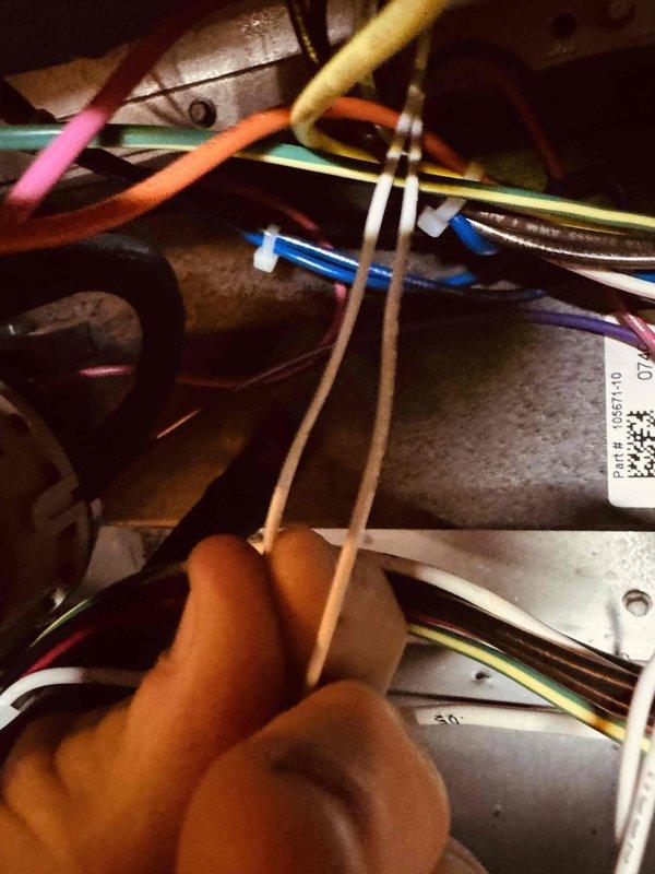 Completed MVP heating maintenance visit and system inspection. Accessed internal HVAC components to verify electrical connections, wire routing, and panel configurations per manufacturer specifications. Documented equipment condition including panel assembly (P/N 903185-03) and internal wiring connections. All colored wire bundles inspected and found properly secured with appropriate wire management. Electrical connections tested and confirmed operational. System components photographed for maintenance records.