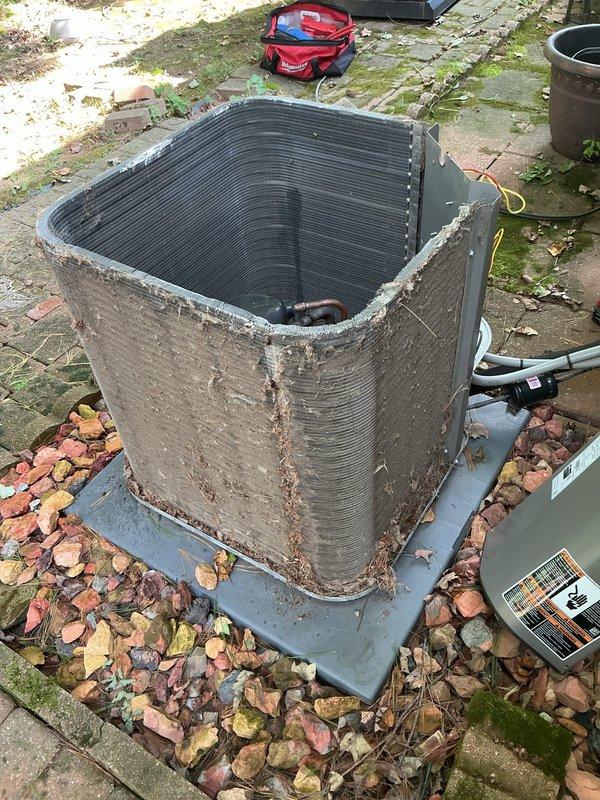 Completed MVP air conditioning maintenance on outdoor condenser unit. Performed comprehensive system inspection, cleaned accumulated debris and leaves from unit exterior and surrounding area, checked refrigerant levels and electrical connections, and verified proper operation of all components. Unit showed signs of age with surface weathering but demonstrated satisfactory performance upon testing.