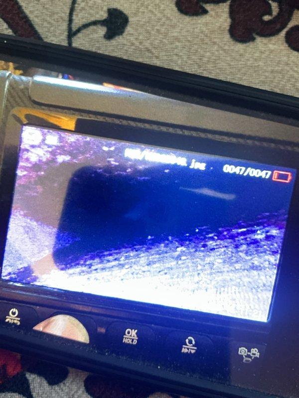 Responded to no cooling complaint on 7-year-old AC system that remained non-functional following previous service visit. Performed comprehensive system evaluation using inspection camera to assess internal components and ductwork connections. Documented refrigerant line routing and plenum configuration, identifying potential issues with system operation that required further diagnostic attention beyond initial assessment.