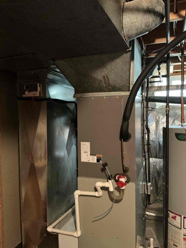 Conducted furnace inspection and identified cracks in the heat exchanger of a 19-year-old unit. Provided replacement estimate and documented existing HVAC equipment including air handler, ductwork, and associated PVC venting system with photographic evidence.