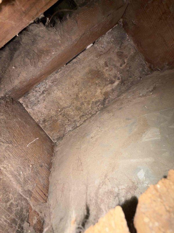 Completed comprehensive duct cleaning service in attic space, removing accumulated dust, debris, and particulate matter from HVAC ductwork and surrounding structural areas. Before-service photos documented heavy dust accumulation on wooden joists, beams, and horizontal surfaces, along with visible debris on attic flooring near ductwork components. Successfully cleaned all accessible duct sections and improved overall indoor air quality by eliminating contaminants from the ventilation system.