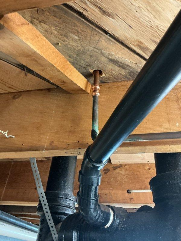 Responded to a hall bathroom toilet leaking at the base with water infiltrating into the basement below. Upon inspection from the basement, identified a broken original cast iron closet flange with a failed repair flange previously installed on top of the damaged original. 

Removed the existing toilet and assessed the full extent of the drainage system failure. Cut out the deteriorated cast iron riser pipe and installed a new transition coupling to convert from cast iron to PVC. Ran new PVC pipe and installed a new closet flange, ensuring proper elevation and secure mounting to the subfloor. Replaced the toilet with a new American Standard Cadet Pro round bowl, right height model, equipped with a slow-close seat. 

Tested the installation for proper operation and verified no leaks at the base or in the basement. Supply line reconnected and system returned to full service.