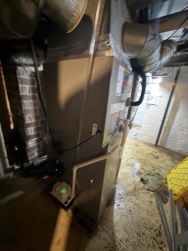 Completed first-time installation of air conditioning system with evaporator coil integrated with existing furnace infrastructure. Installed new A/C unit with proper refrigerant line connections, condensate drainage via PVC piping, and ductwork modifications to accommodate the evaporator coil mounted to the existing furnace plenum. All electrical connections completed, system tested for proper operation, and airflow verified through galvanized ductwork system.