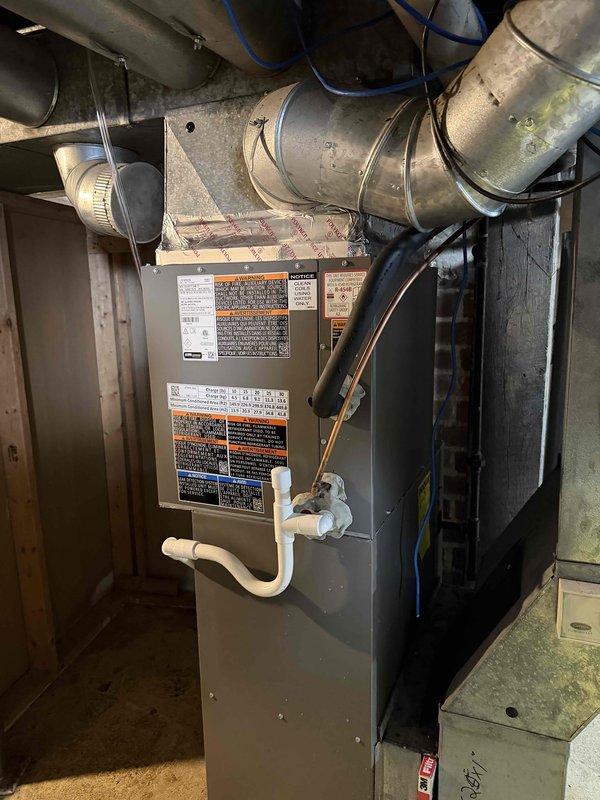 Completed first-time installation of air conditioning system with evaporator coil integrated with existing furnace infrastructure. Installed new A/C unit with proper refrigerant line connections, condensate drainage via PVC piping, and ductwork modifications to accommodate the evaporator coil mounted to the existing furnace plenum. All electrical connections completed, system tested for proper operation, and airflow verified through galvanized ductwork system.