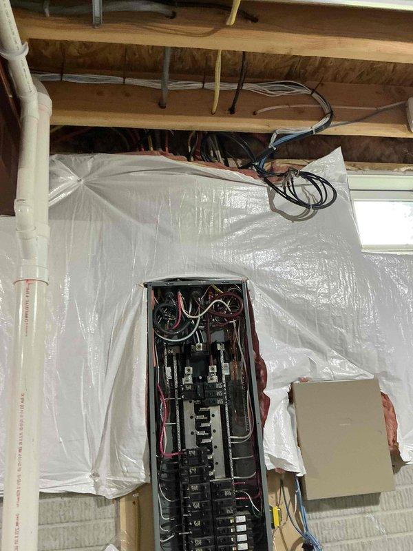Conducted electrical estimate for Generac generator installation at residential property. Evaluated existing transfer switch already present on-site and assessed electrical panel configuration in attic space to determine compatibility and connection requirements. Inspected circuit breaker panel, existing wiring infrastructure, and available routing paths through exposed joists for proper integration of generator system. Documented current electrical setup including panel capacity, breaker arrangement, and wire management to provide accurate scope of work for generator installation project.