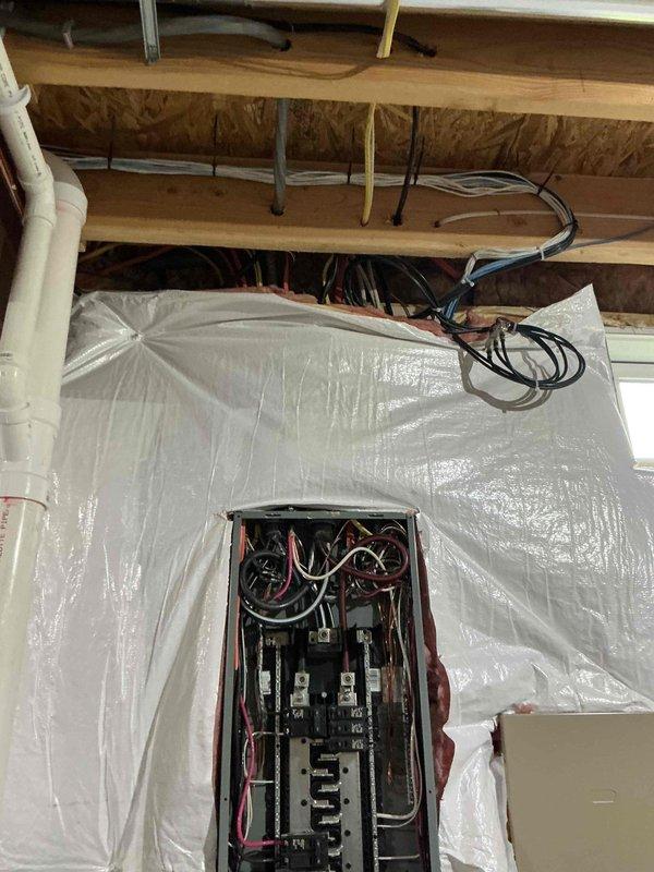 Conducted electrical estimate for Generac generator installation at residential property. Evaluated existing transfer switch already present on-site and assessed electrical panel configuration in attic space to determine compatibility and connection requirements. Inspected circuit breaker panel, existing wiring infrastructure, and available routing paths through exposed joists for proper integration of generator system. Documented current electrical setup including panel capacity, breaker arrangement, and wire management to provide accurate scope of work for generator installation project.