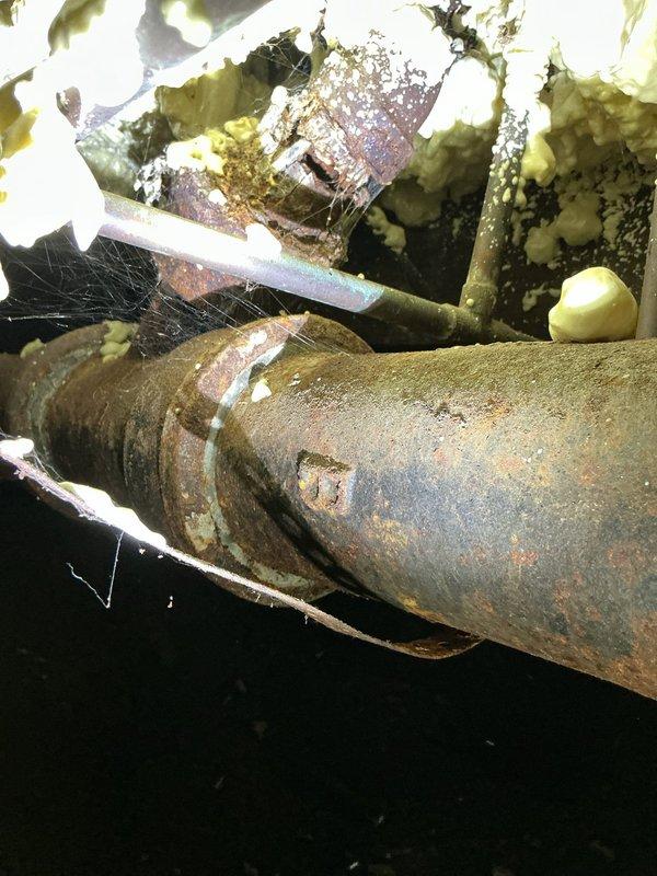 Responded to service call for plumbing issues discovered during previous work under the residence. Upon inspection, confirmed a hole in the cast iron drain pipe located beneath the bathroom sink in the crawl space. The cast iron pipe showed severe corrosion and deterioration consistent with age and moisture exposure. Additionally, assessed multiple inline shut-off valves throughout the plumbing system and confirmed they are seized in place and inoperative due to corrosion. Documented conditions with photographs showing the extent of pipe deterioration and non-functional isolation valves. Advised property owner of findings and recommended replacement of the damaged cast iron section and frozen shut-off valves to restore proper function and prevent potential water damage.